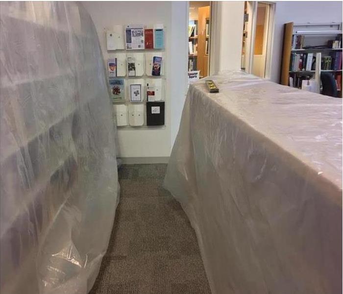plastic sheets covering books in cases